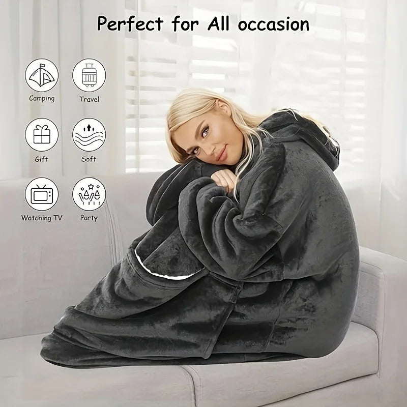 Soft comfortable large hooded blanket in black, warm and wearable for indoor use. Features an oversized fit with a spacious front pocket holding a cat.